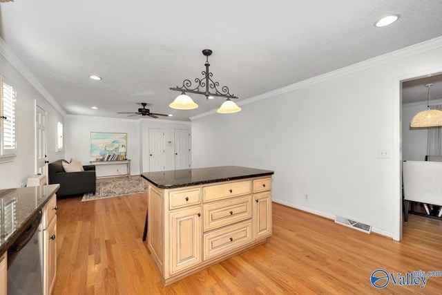 kitchen featuring stainless steel dishwasher, dark stone counters, a center island, and hanging light fixtures