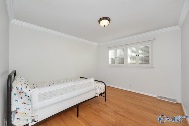 bedroom featuring hardwood / wood-style flooring and ornamental molding