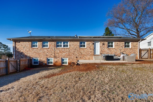 back of property featuring an outdoor living space, a patio area, and a lawn