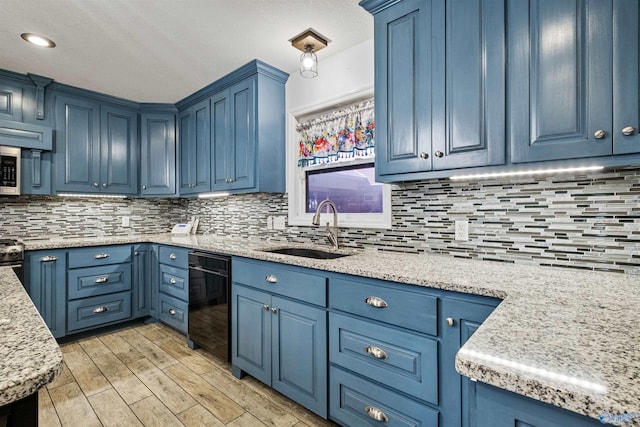 kitchen featuring backsplash, blue cabinets, and sink