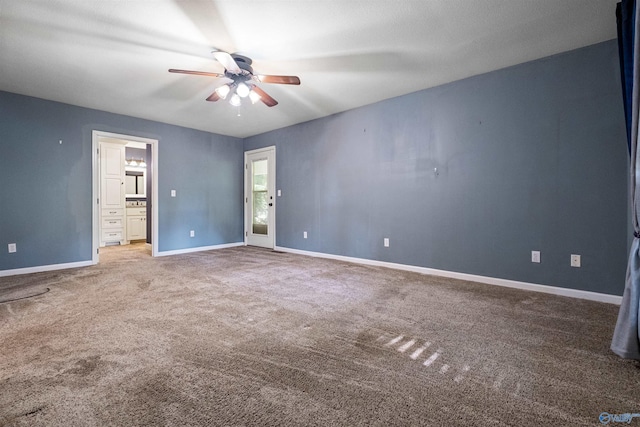 carpeted spare room featuring ceiling fan