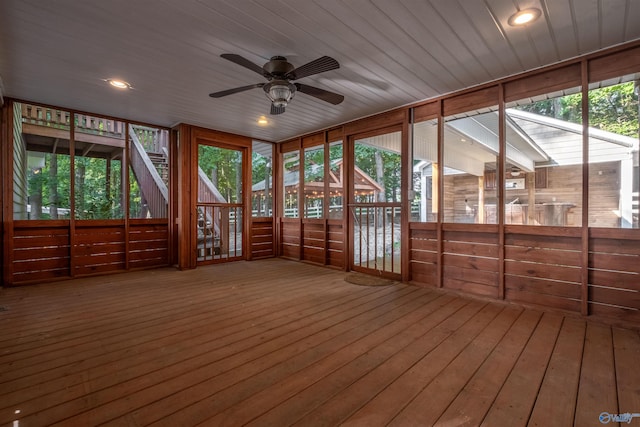 unfurnished sunroom with ceiling fan and plenty of natural light