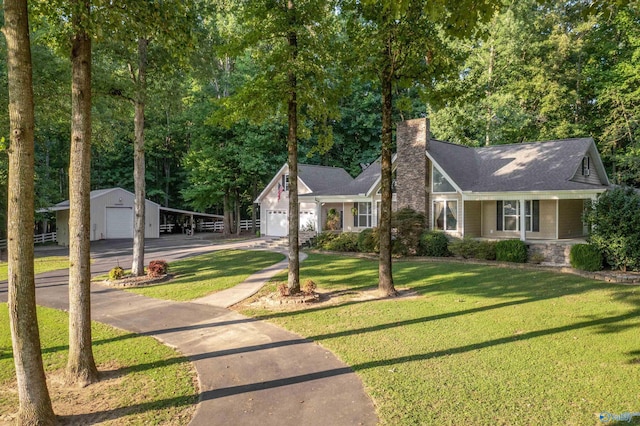 view of front facade with a front lawn, an outdoor structure, and a garage