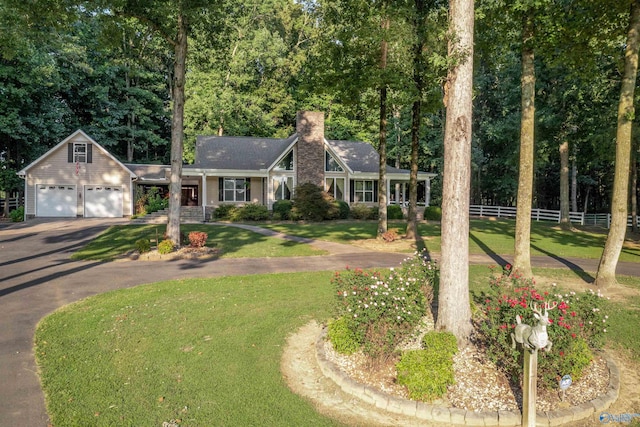 view of front of house with a front yard and a garage