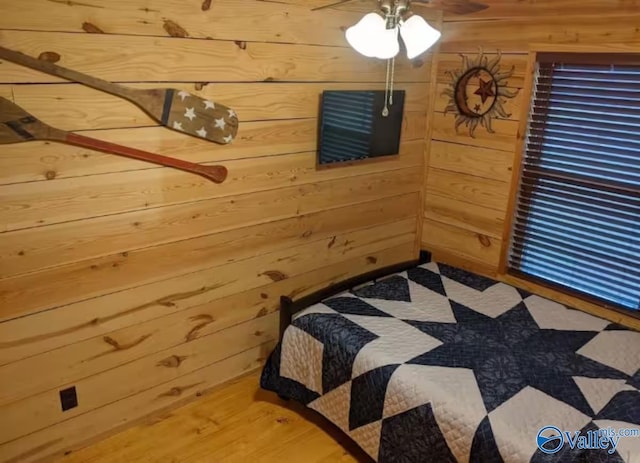 unfurnished bedroom featuring wooden walls