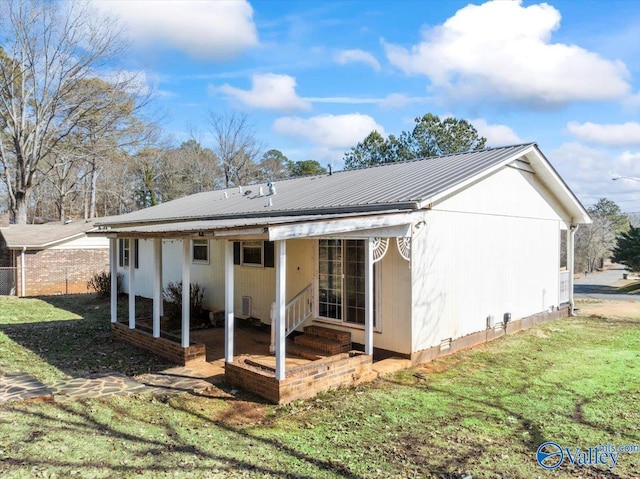 back of property with a lawn