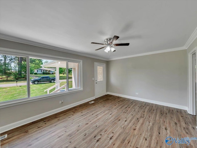 1419 11th St SE, Cullman, AL 35055 - unfurnished room featuring crown molding, visible vents, wood finished floors, baseboards, and a ceiling fan