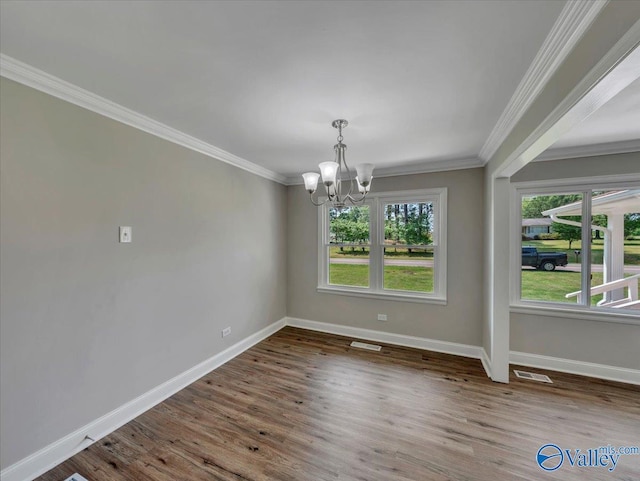 1419 11th St SE, Cullman, AL 35055 - unfurnished dining area with visible vents, crown molding, wood finished floors, baseboards, and an inviting chandelier