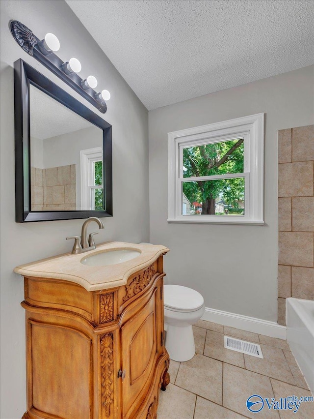 1419 11th St SE, Cullman, AL 35055 - full bath with visible vents, vanity, a textured ceiling, a bath, and tile patterned floors