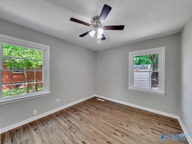 1419 11th St SE, Cullman, AL 35055 - spare room featuring baseboards, a textured ceiling, ceiling fan, and wood finished floors