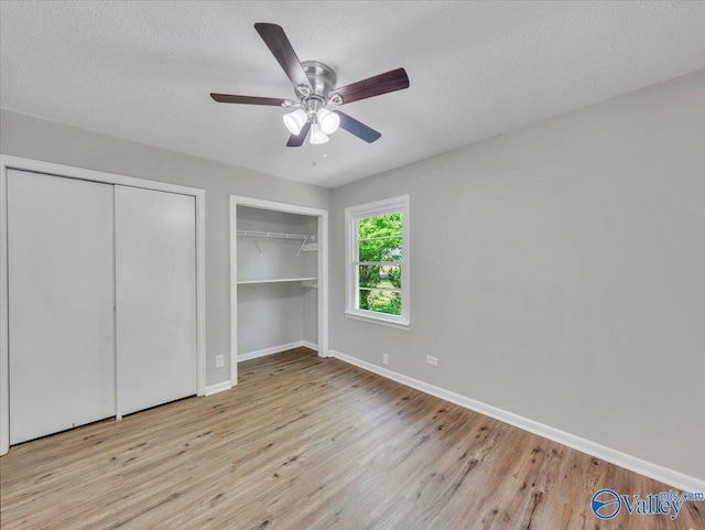 1419 11th St SE, Cullman, AL 35055 - unfurnished bedroom with two closets, baseboards, and wood finished floors