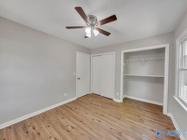 1419 11th St SE, Cullman, AL 35055 - unfurnished bedroom featuring baseboards, multiple closets, and wood finished floors