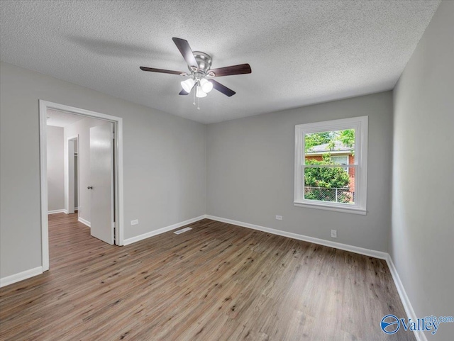 1419 11th St SE, Cullman, AL 35055 - unfurnished room with a ceiling fan, a textured ceiling, visible vents, wood finished floors, and baseboards