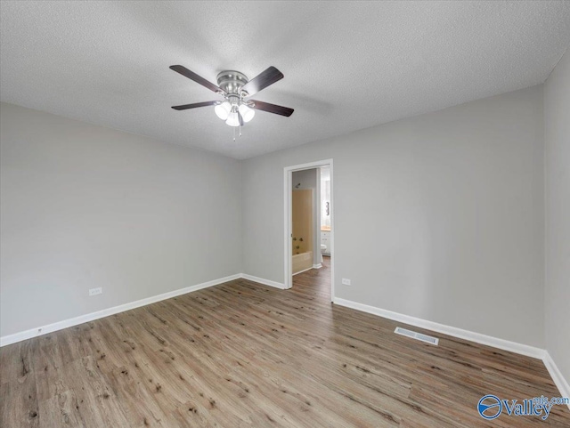 1419 11th St SE, Cullman, AL 35055 - empty room with visible vents, a ceiling fan, baseboards, and wood finished floors