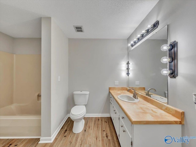 1419 11th St SE, Cullman, AL 35055 - full bath featuring toilet, visible vents, wood finished floors, and vanity