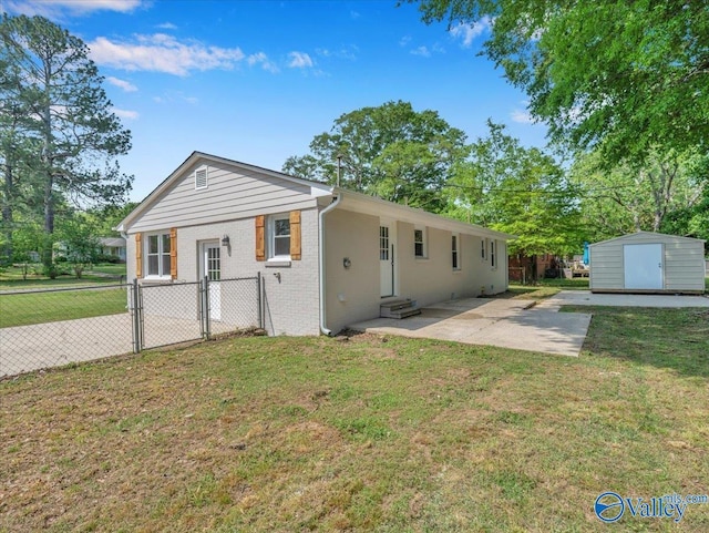 1419 11th St SE, Cullman, AL 35055 - back of house featuring a storage shed, fence, a yard, and brick siding