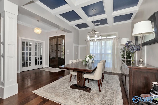 dining area featuring dark wood-type flooring, coffered ceiling, french doors, beam ceiling, and an inviting chandelier