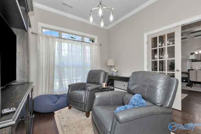 living room with dark wood-type flooring, visible vents, and ornamental molding