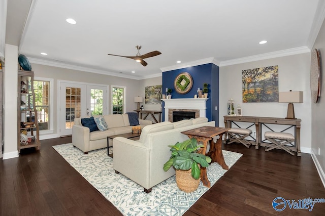 living room with recessed lighting, a fireplace, wood finished floors, baseboards, and crown molding