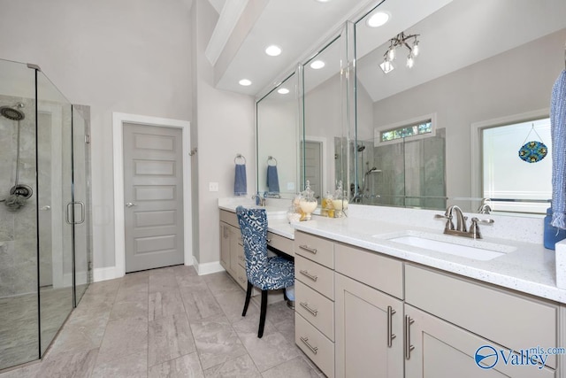 bathroom featuring a stall shower, baseboards, and vanity