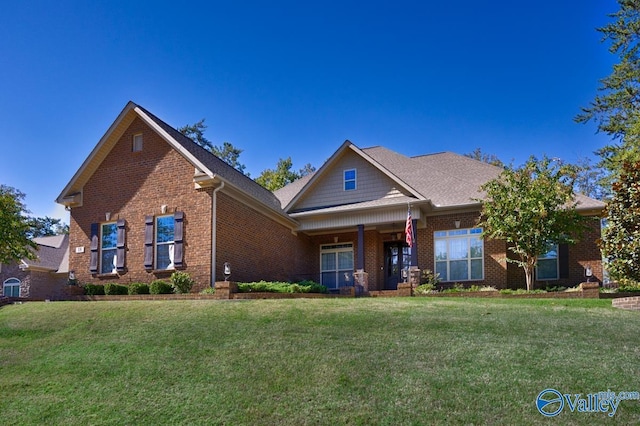 view of front of home with brick siding and a front lawn