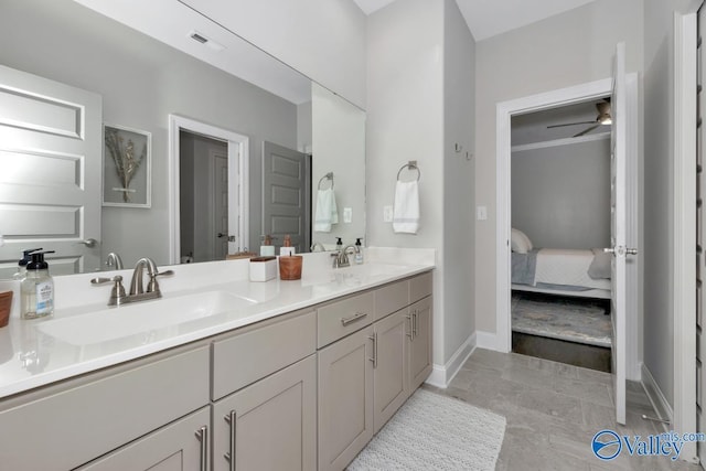 ensuite bathroom with ensuite bathroom, double vanity, a sink, and visible vents