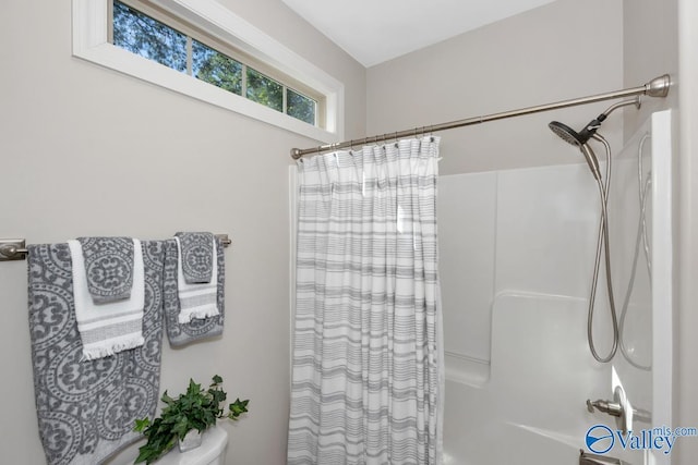 full bath featuring shower / bath combo and toilet