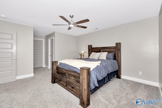 carpeted bedroom with a ceiling fan, visible vents, and baseboards