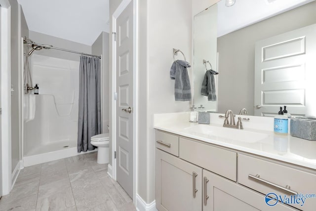 bathroom featuring toilet, vanity, and a shower with shower curtain