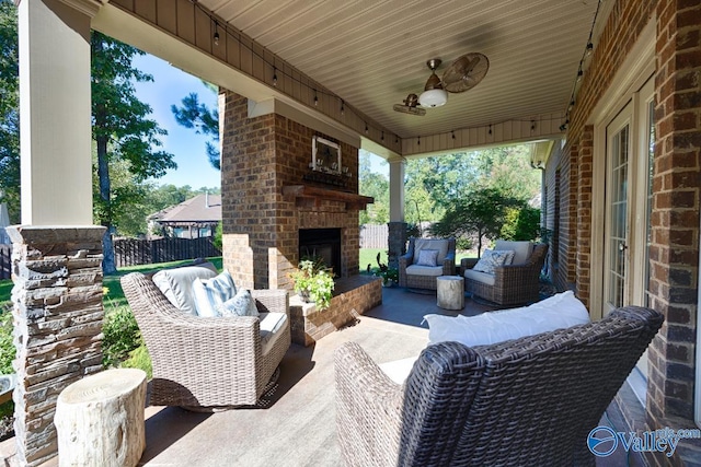 view of patio / terrace featuring an outdoor living space with a fireplace and fence