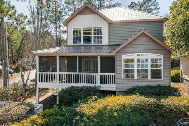 view of front facade featuring a sunroom and metal roof