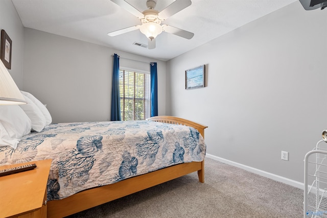 carpeted bedroom featuring baseboards, visible vents, and ceiling fan