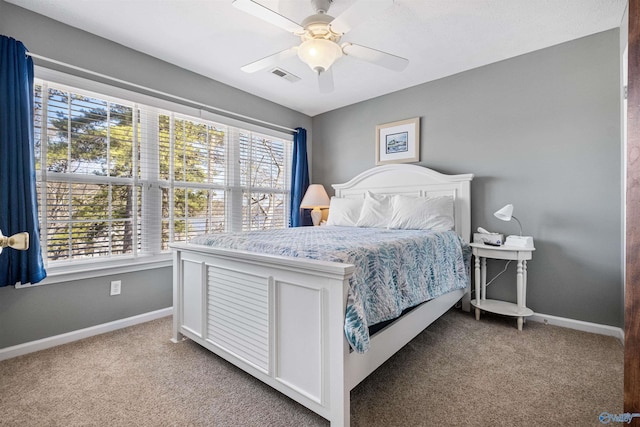 carpeted bedroom featuring visible vents, a ceiling fan, and baseboards