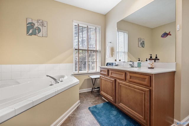 full bathroom with tile patterned flooring, vanity, a bath, and baseboards