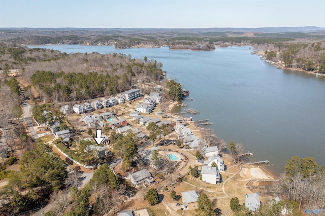 birds eye view of property featuring a water view and a view of trees