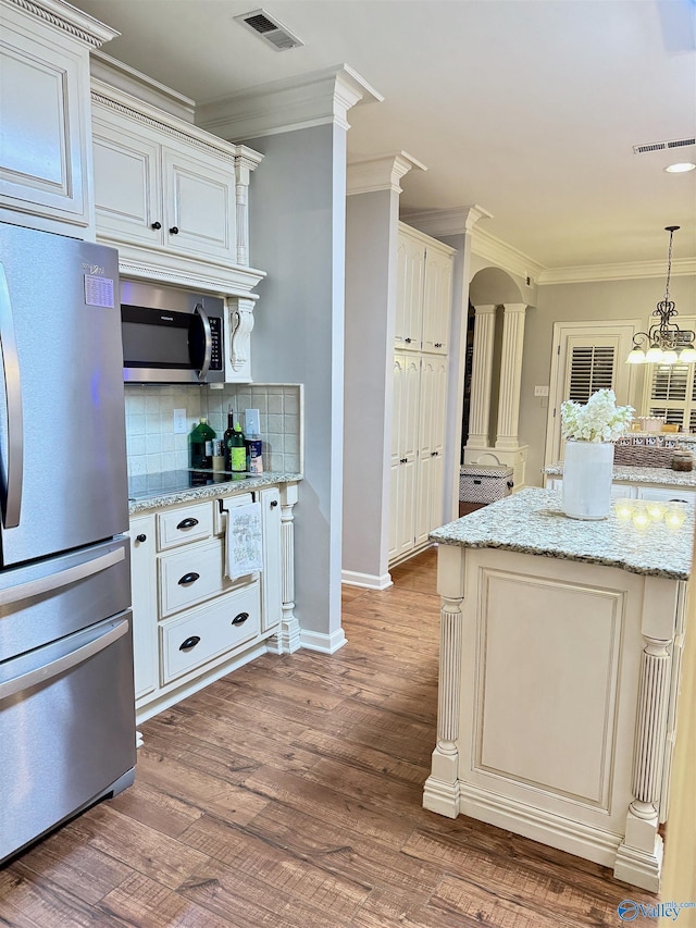 3205 Germantown Pl, Decatur, AL 35603 - kitchen featuring stainless steel appliances, backsplash, crown molding, dark wood finished floors, and light stone counters