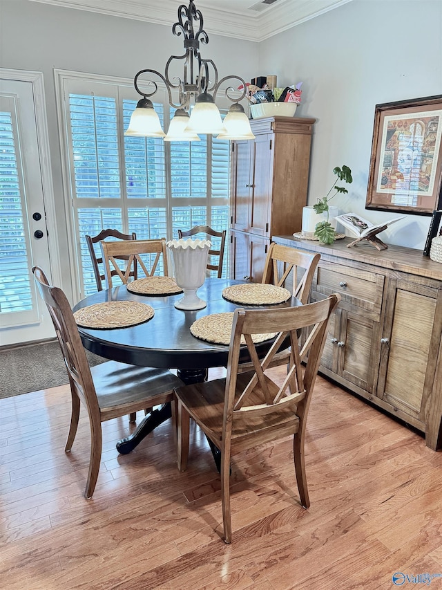3205 Germantown Pl, Decatur, AL 35603 - dining space with ornamental molding, a chandelier, and light wood-style flooring