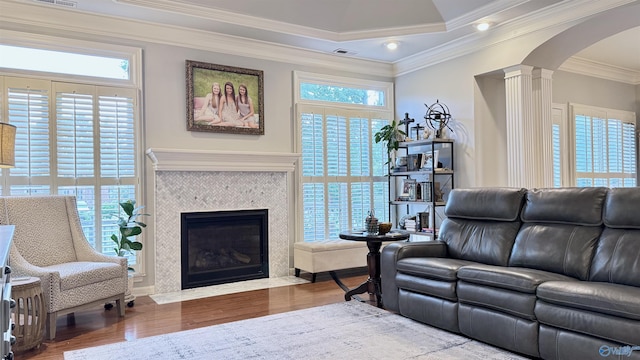 3205 Germantown Pl, Decatur, AL 35603 - living room with decorative columns, arched walkways, wood finished floors, ornamental molding, and a fireplace