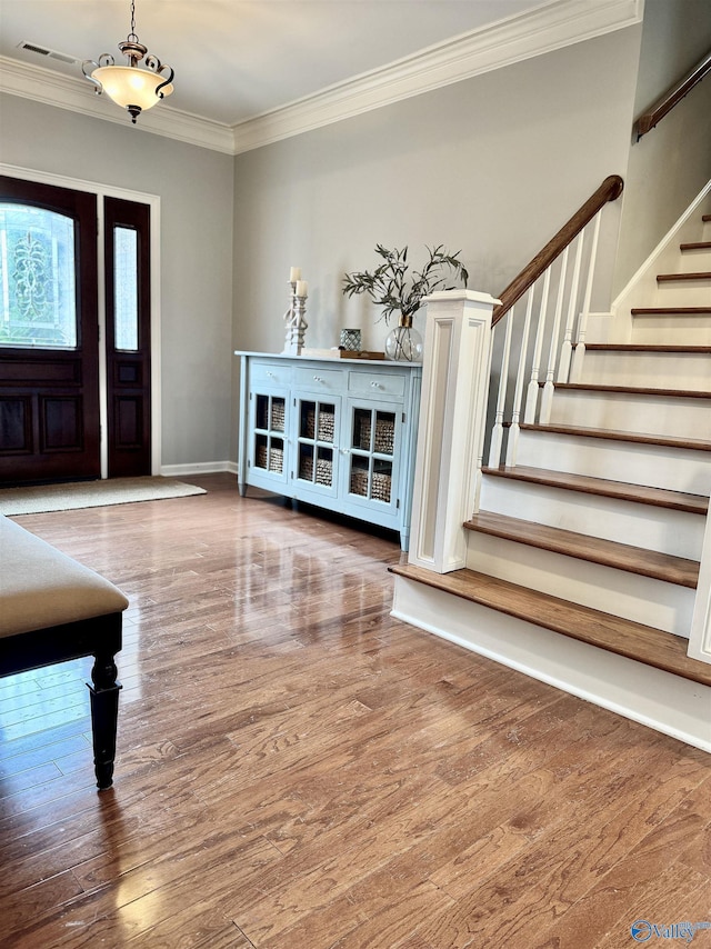 3205 Germantown Pl, Decatur, AL 35603 - entryway featuring crown molding, stairs, wood finished floors, and baseboards