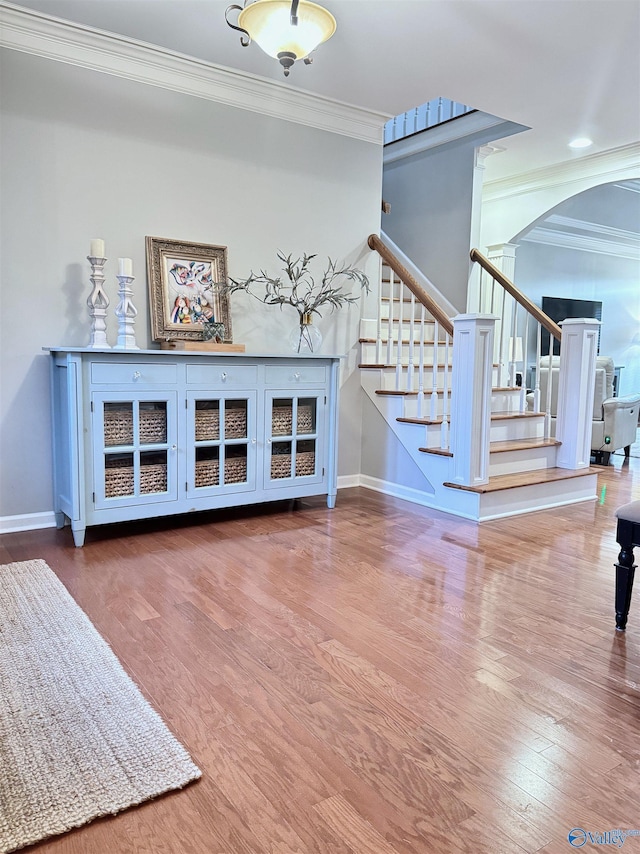 3205 Germantown Pl, Decatur, AL 35603 - living room featuring ornamental molding, arched walkways, wood finished floors, baseboards, and stairs