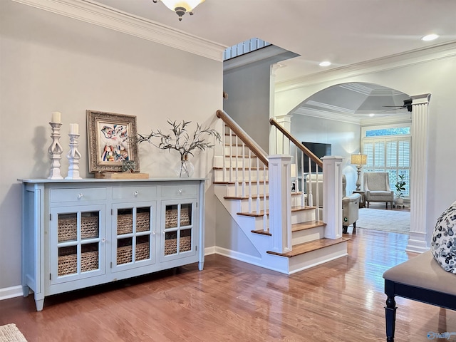 3205 Germantown Pl, Decatur, AL 35603 - stairway with arched walkways, wood finished floors, crown molding, baseboards, and ceiling fan