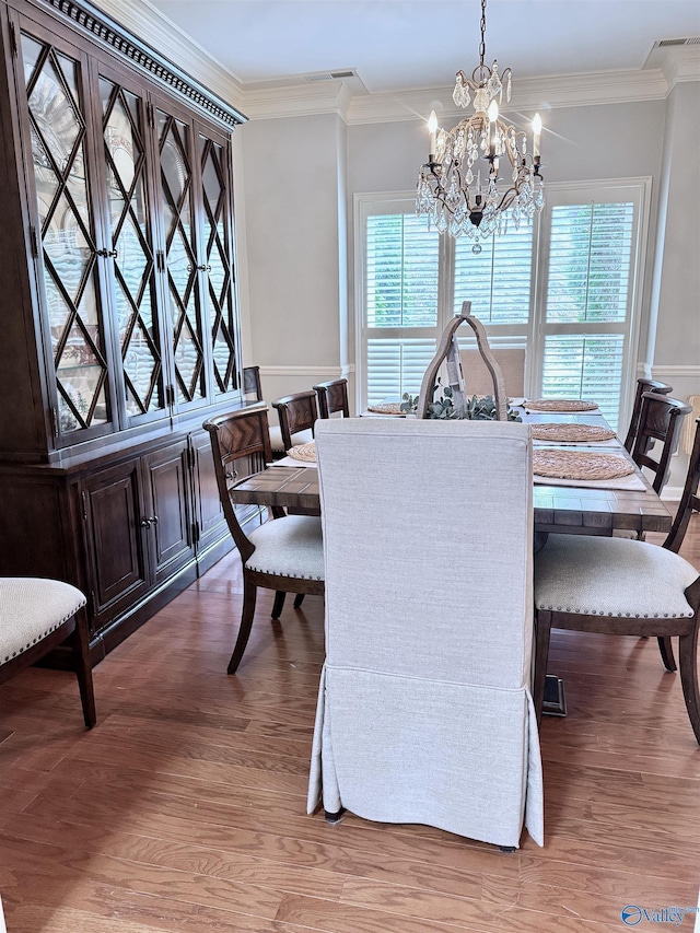 3205 Germantown Pl, Decatur, AL 35603 - dining room with a chandelier, wood finished floors, and ornamental molding