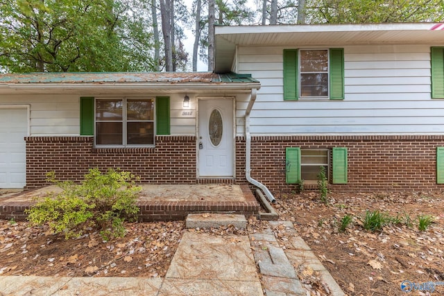 doorway to property featuring a garage