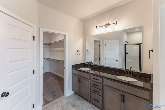 bathroom featuring an enclosed shower and vanity