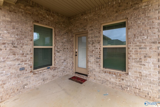 view of exterior entry featuring a patio