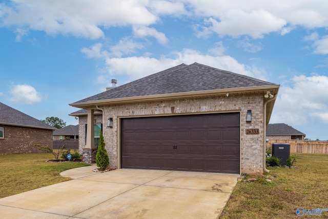 view of front of house featuring a garage and a front lawn