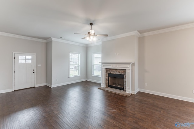 unfurnished living room featuring dark hardwood / wood-style flooring, a fireplace, ornamental molding, and ceiling fan