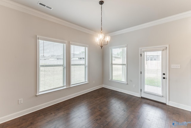 unfurnished dining area featuring an inviting chandelier, crown molding, and dark hardwood / wood-style floors