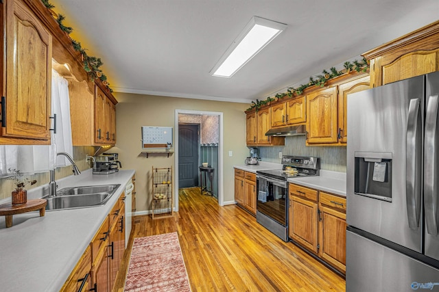 kitchen featuring backsplash, light hardwood / wood-style floors, sink, stainless steel appliances, and ornamental molding