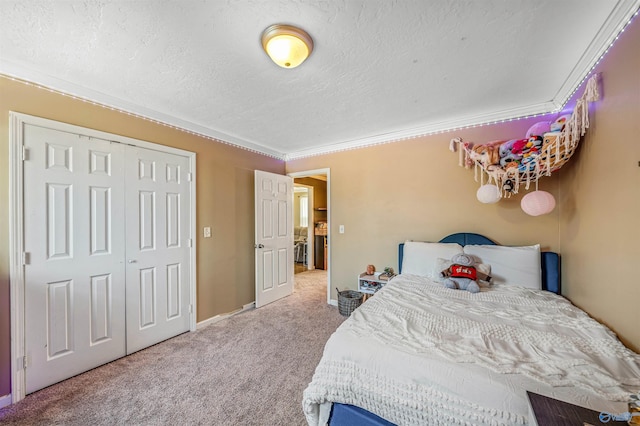 bedroom with carpet floors, a textured ceiling, a closet, and ornamental molding